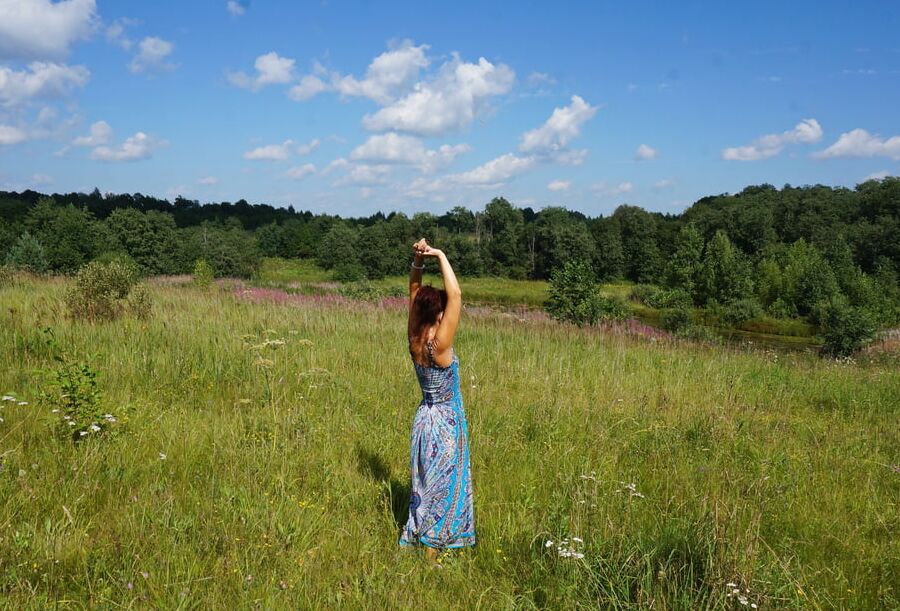 In blue dress in field