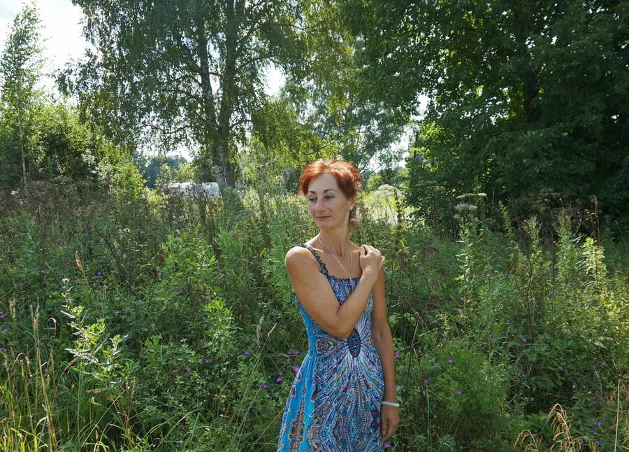 In blue dress in field