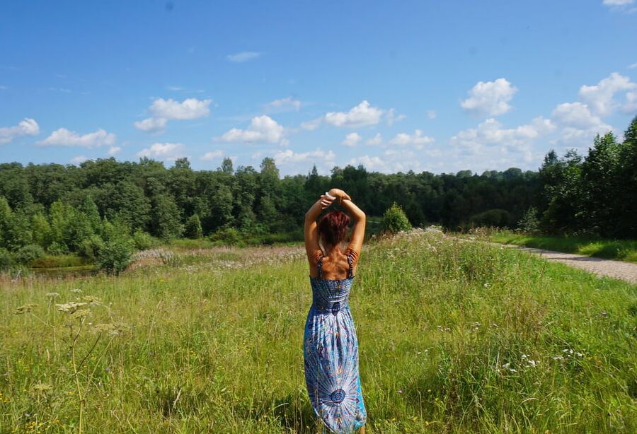 In blue dress in field