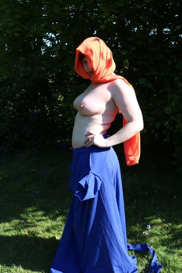 Hijab and abaya flashing outdoors