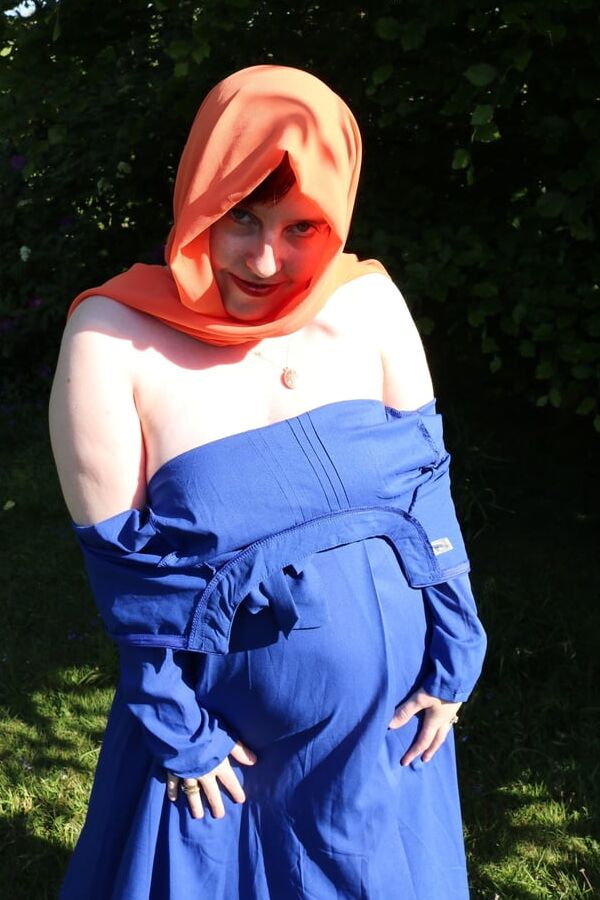 Hijab and abaya flashing outdoors