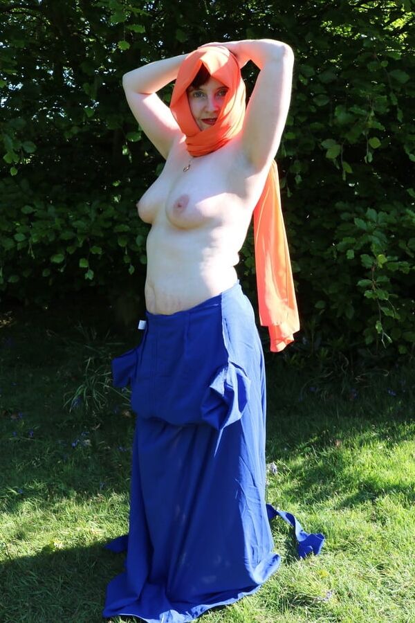 Hijab and abaya flashing outdoors
