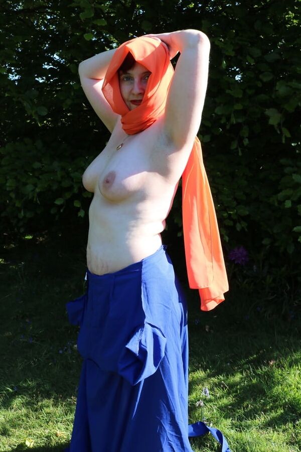 Hijab and abaya flashing outdoors