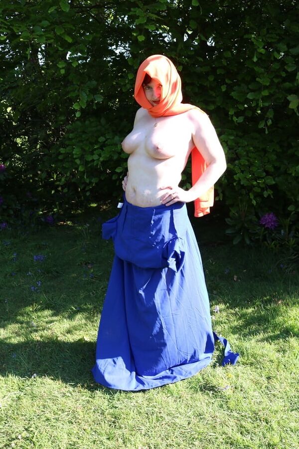 Hijab and abaya flashing outdoors