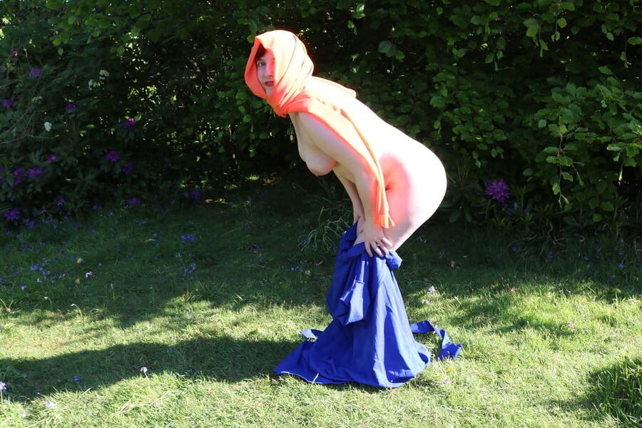 Hijab and abaya flashing outdoors