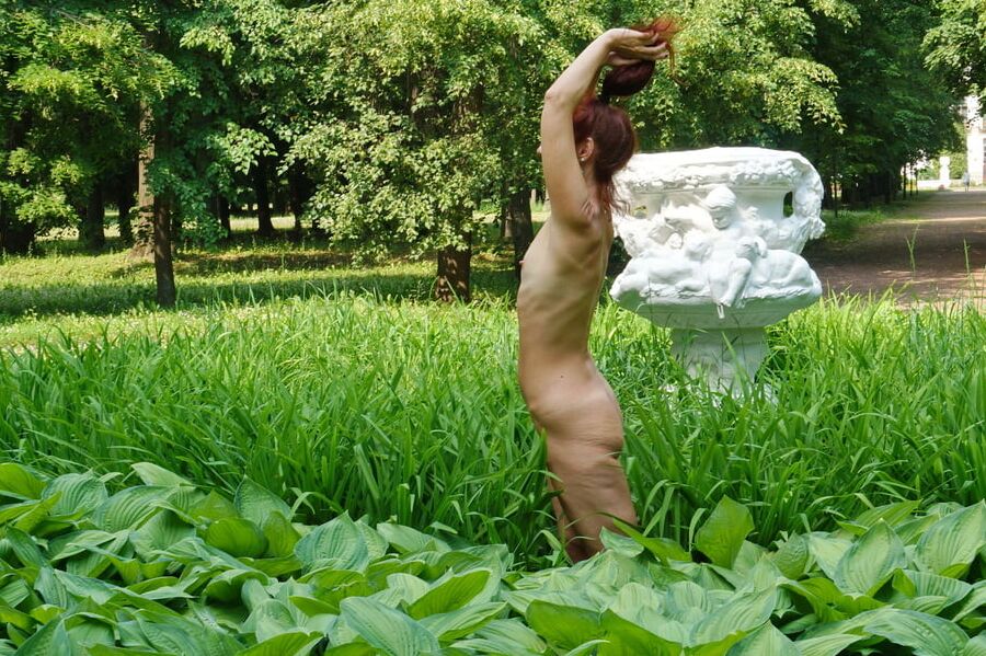 Naked in the grass by the vase
