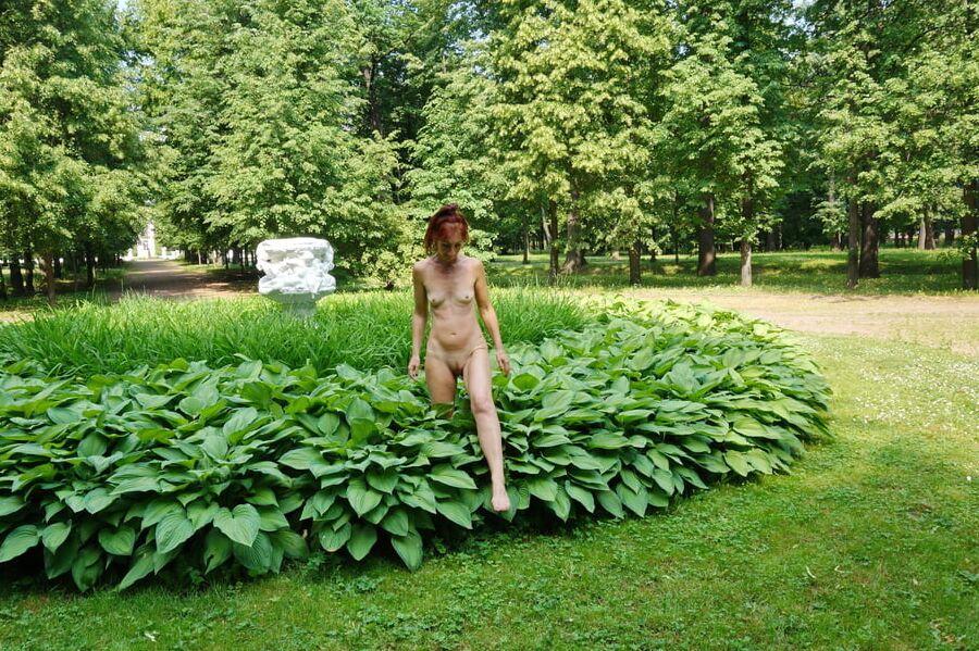 Naked in the grass by the vase