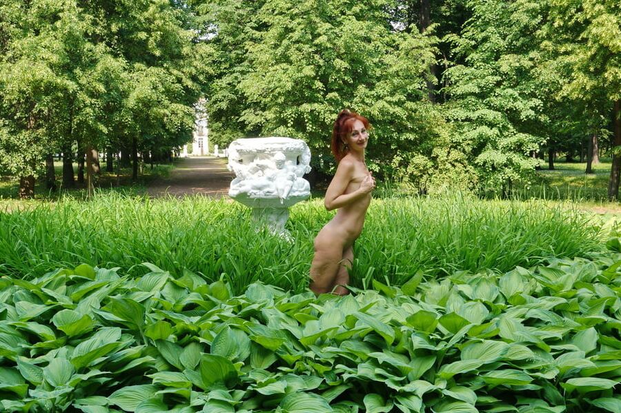 Naked in the grass by the vase