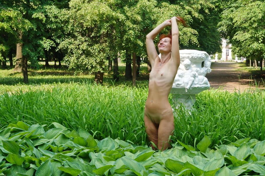 Naked in the grass by the vase