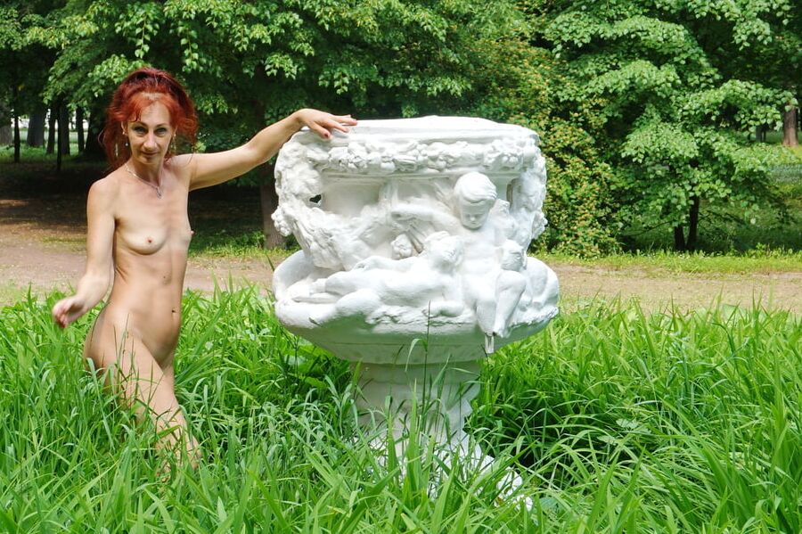 Naked in the grass by the vase