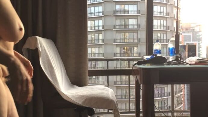 Mature masturbating GILF plays peek-a-boo with the city