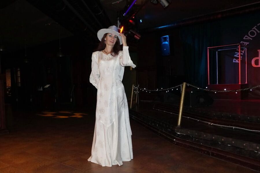 In Wedding Dress and White Hat on stage