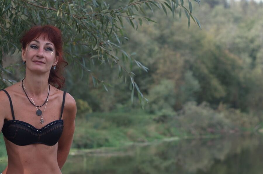 Black bikini near tree upon river