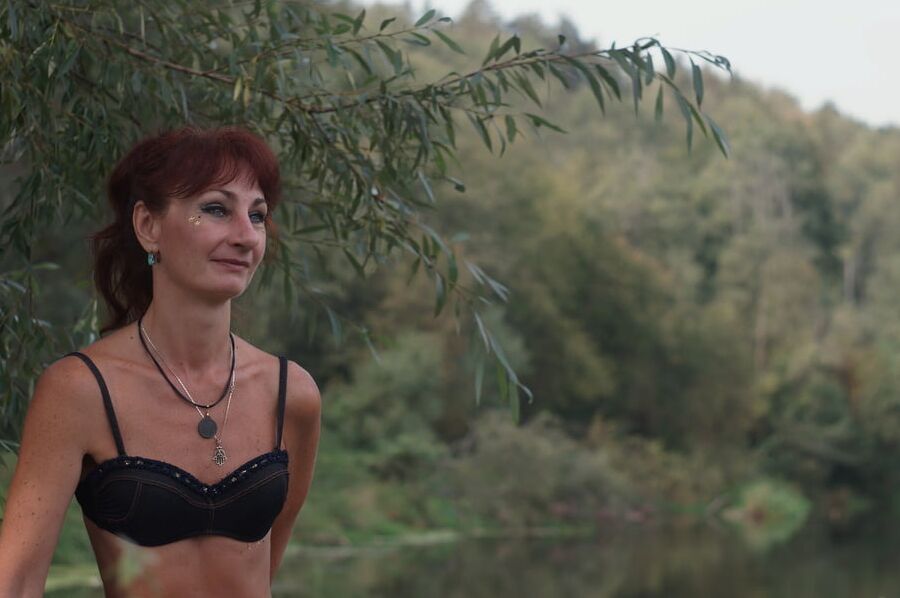 Black bikini near tree upon river