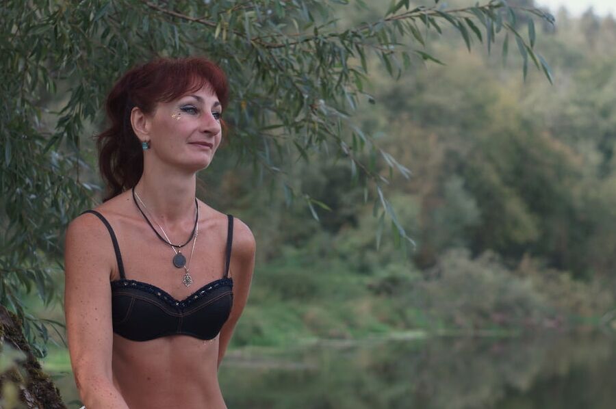 Black bikini near tree upon river
