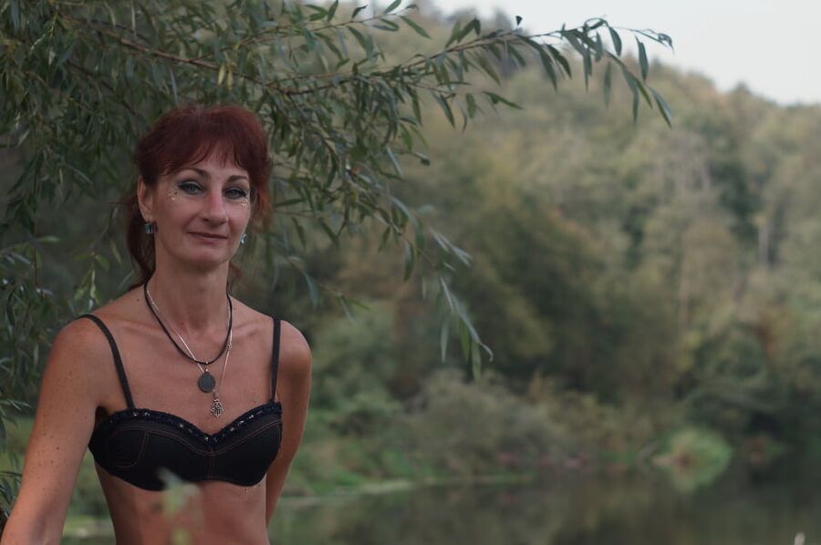 Black bikini near tree upon river