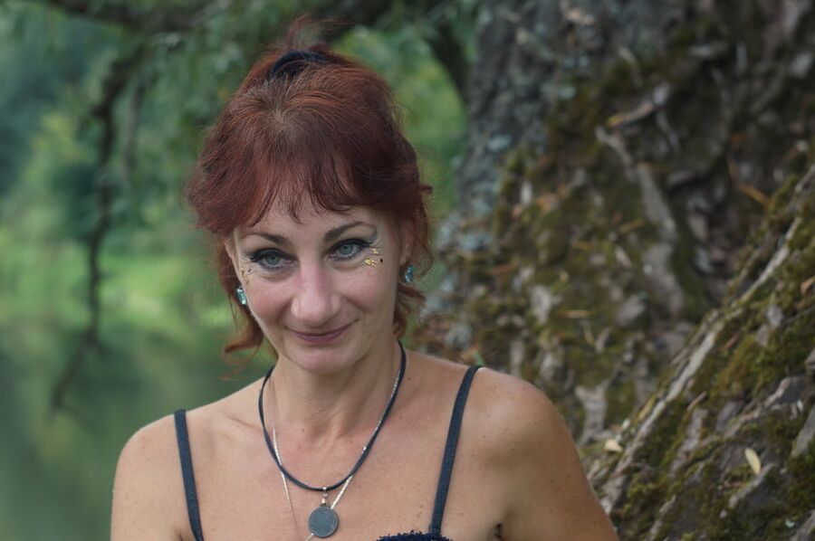 Black bikini near tree upon river