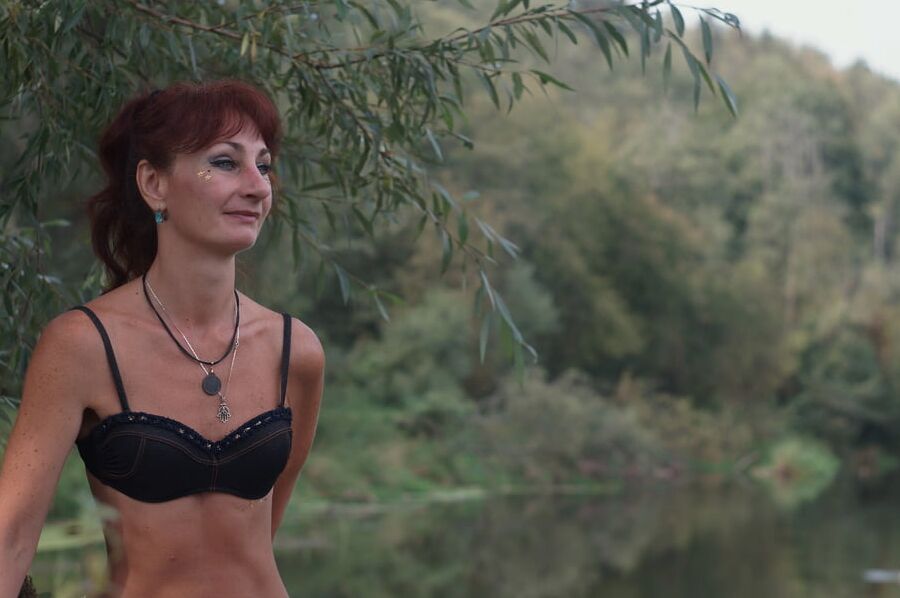 Black bikini near tree upon river
