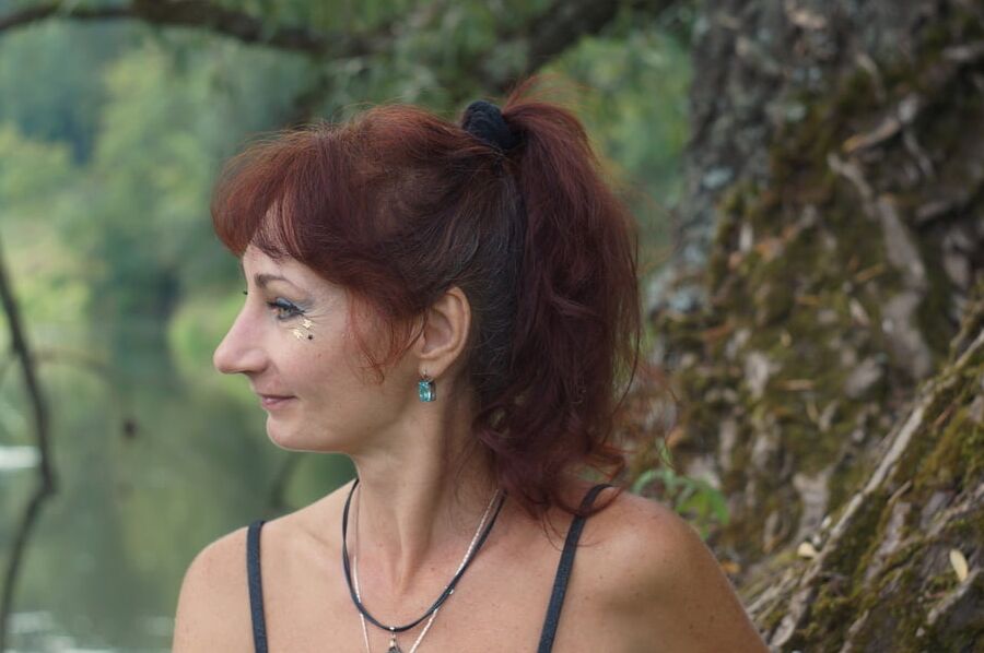 Black bikini near tree upon river