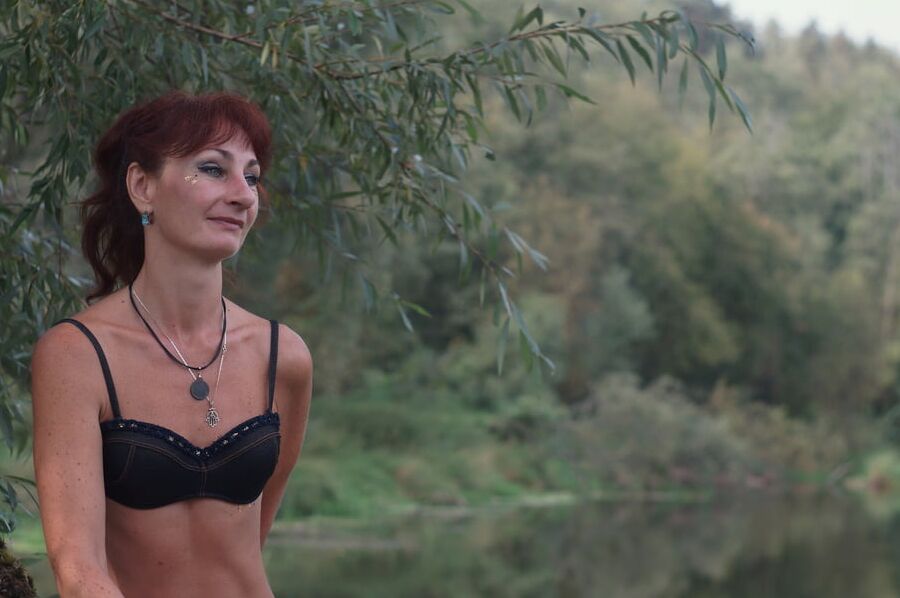 Black bikini near tree upon river