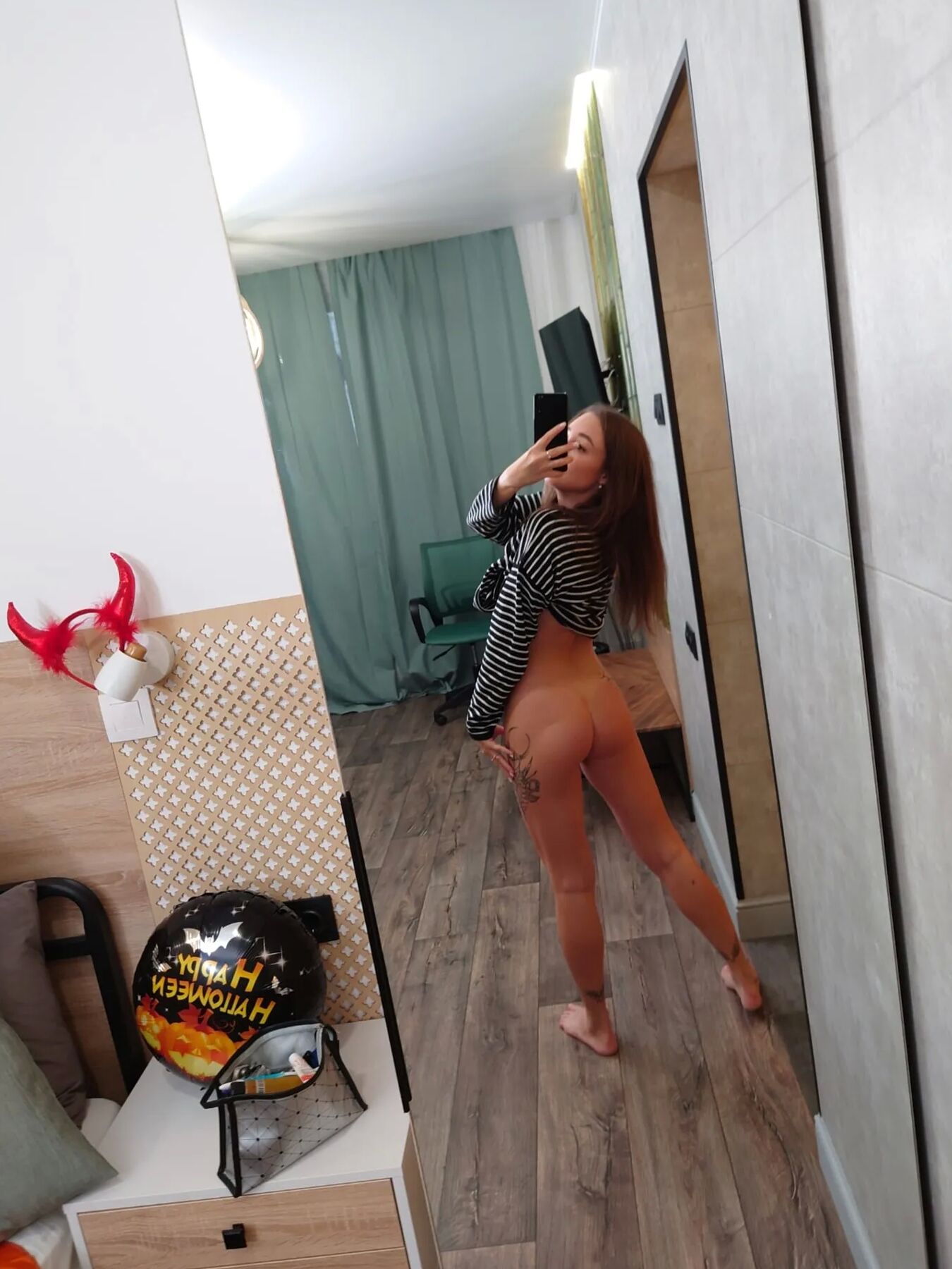 Skinny tattooed teen showing off her legs