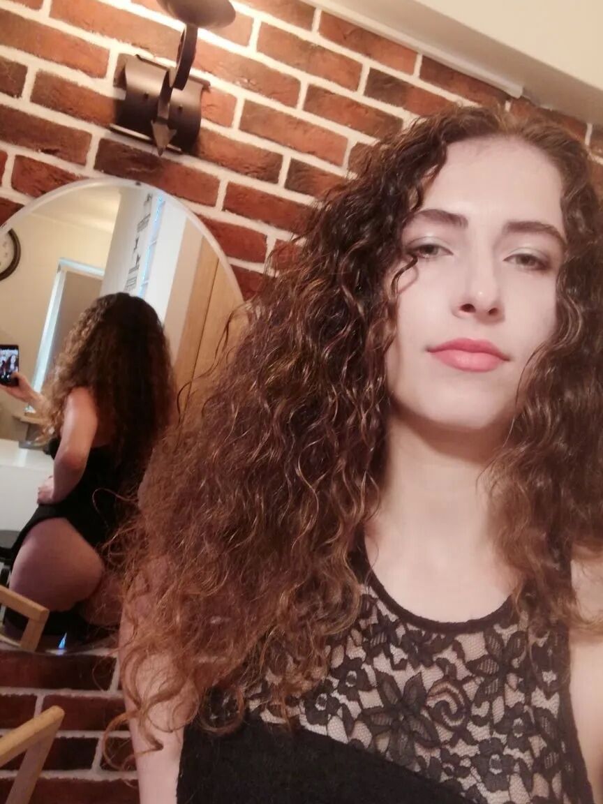 Cutie with curly brunette hair shows her tits