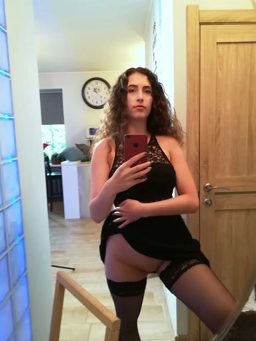 Cutie with curly brunette hair shows her tits