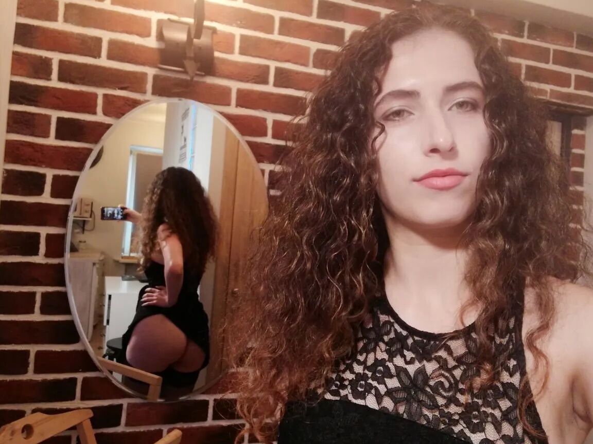 Cutie with curly brunette hair shows her tits