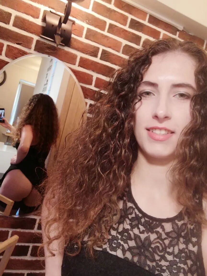 Cutie with curly brunette hair shows her tits