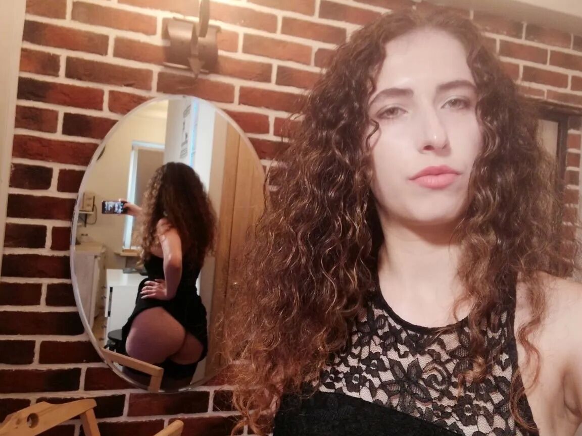 Cutie with curly brunette hair shows her tits