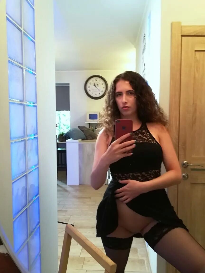 Cutie with curly brunette hair shows her tits