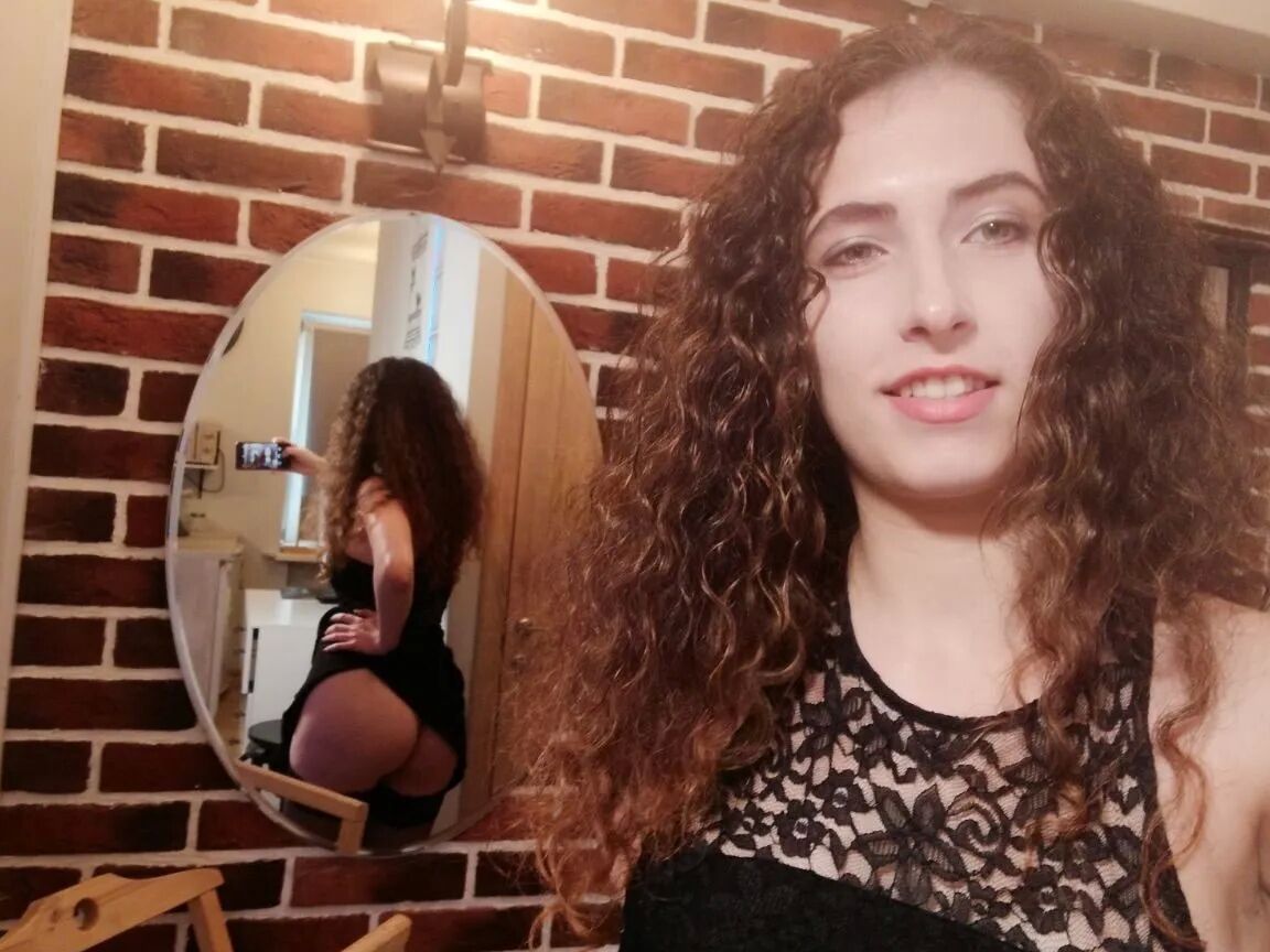Cutie with curly brunette hair shows her tits