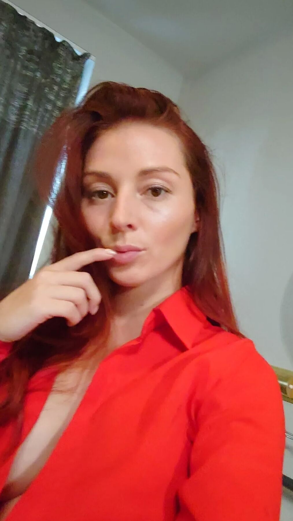Naughty redhead reveals her big tits on cam