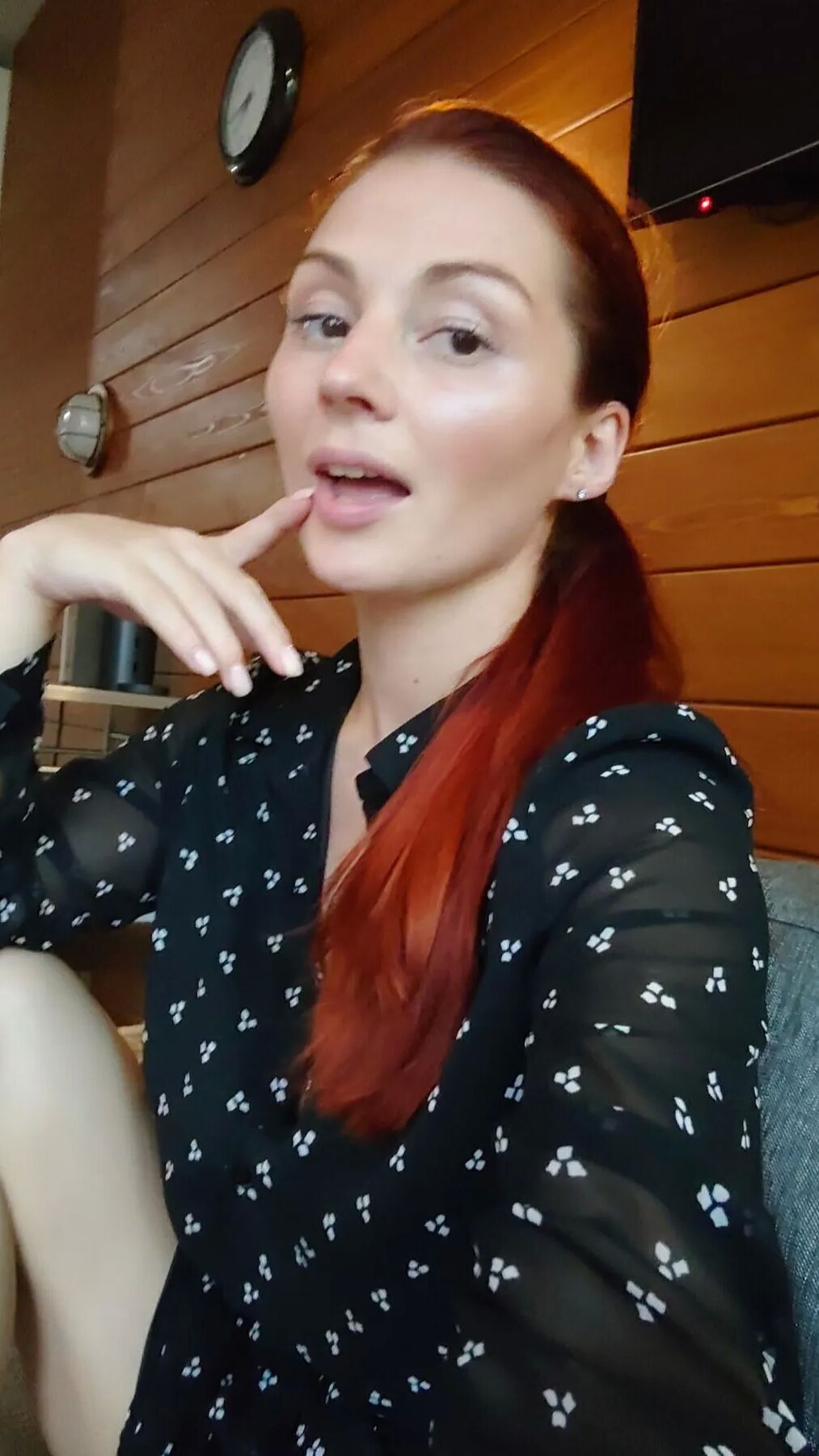 Naughty redhead reveals her big tits on cam