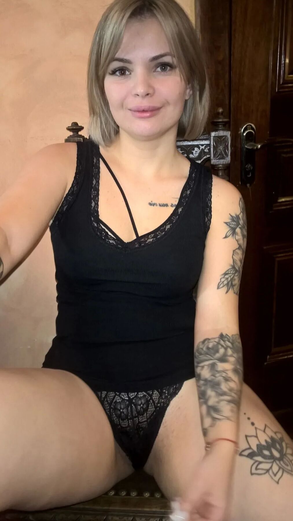 Short-haired hottie shows her small perky tits
