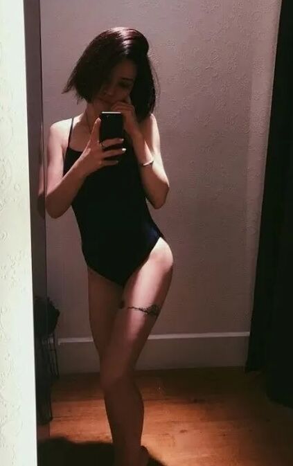 Dark-haired cutie gets naked and poses for you
