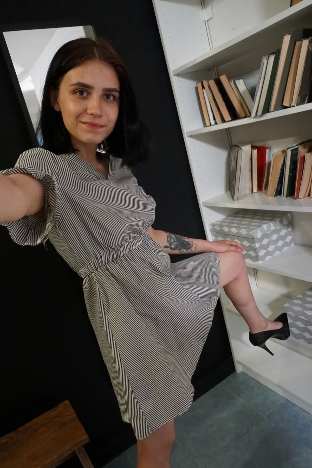 Pale cutie with a tattoo undressing passionately