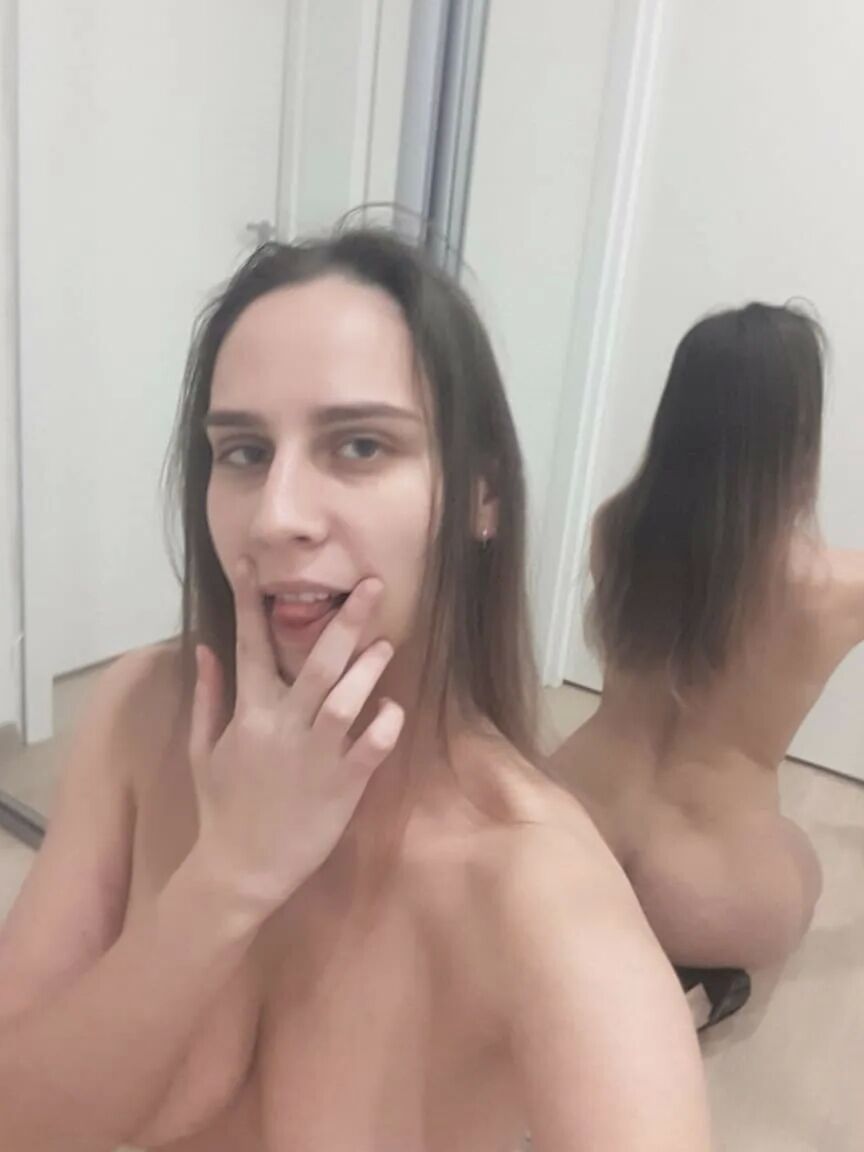 Foxy brunette shows us her tongue while posing