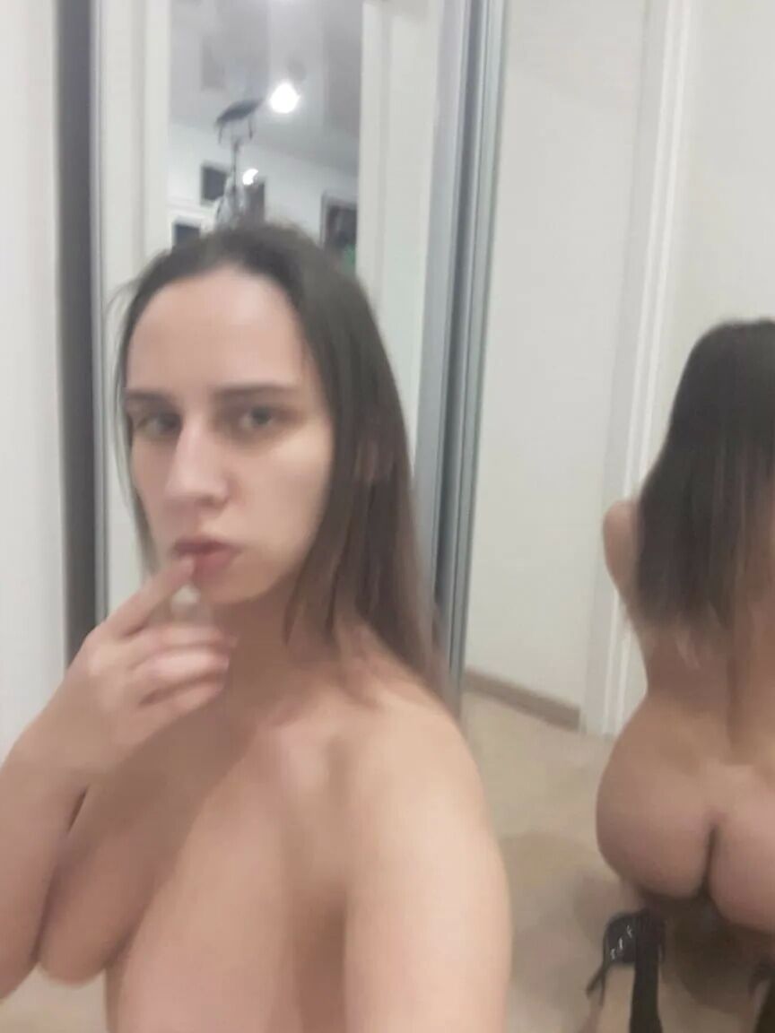 Foxy brunette shows us her tongue while posing