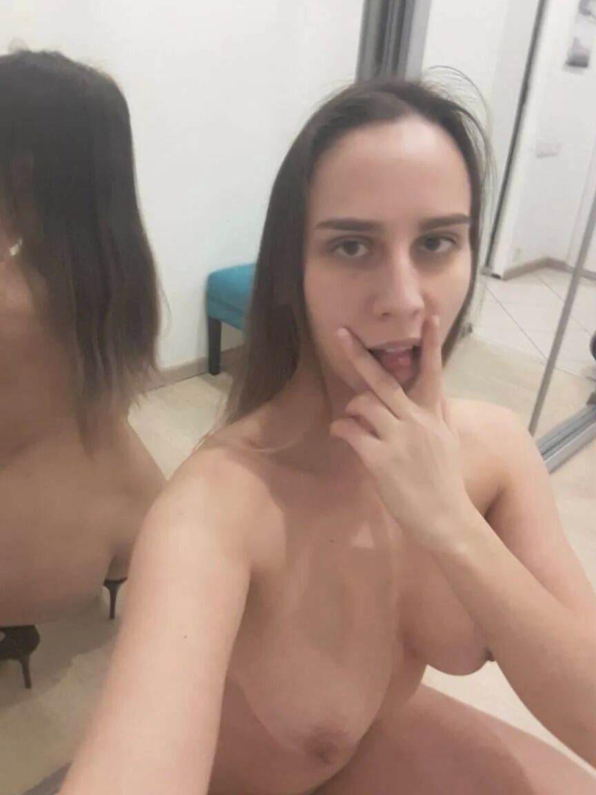Foxy brunette shows us her tongue while posing