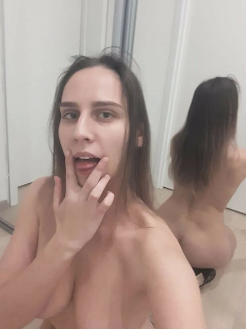 Foxy brunette shows us her tongue while posing