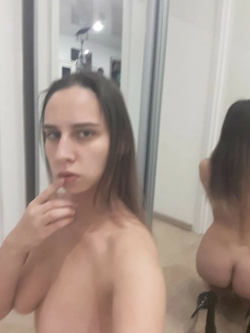 Foxy brunette shows us her tongue while posing