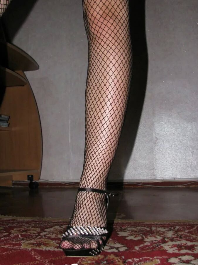 Hot babe trying out some fishnets with heels