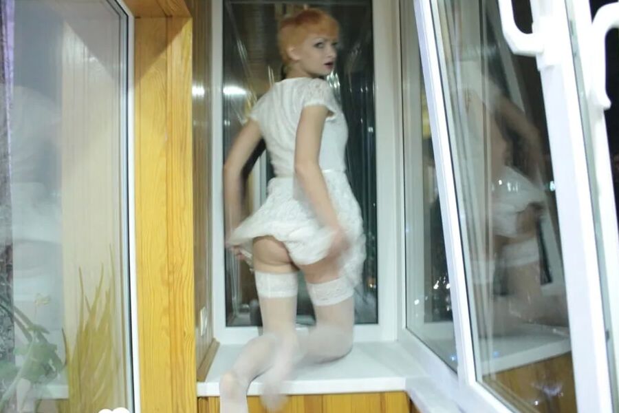 Hottie sits by the window in an outfit