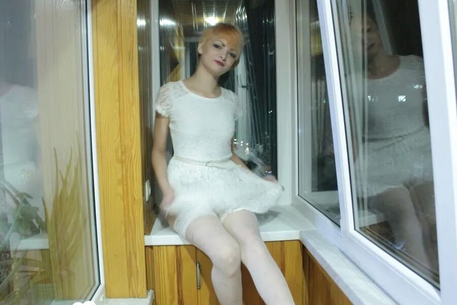 Hottie sits by the window in an outfit