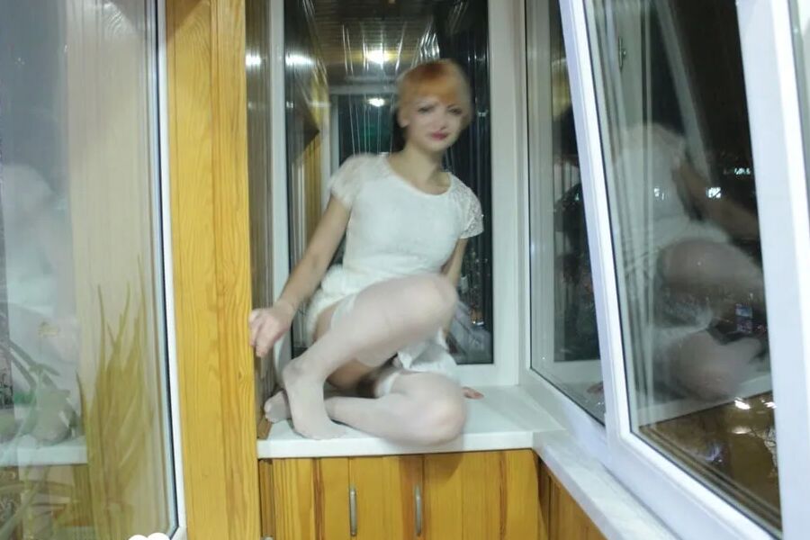 Hottie sits by the window in an outfit