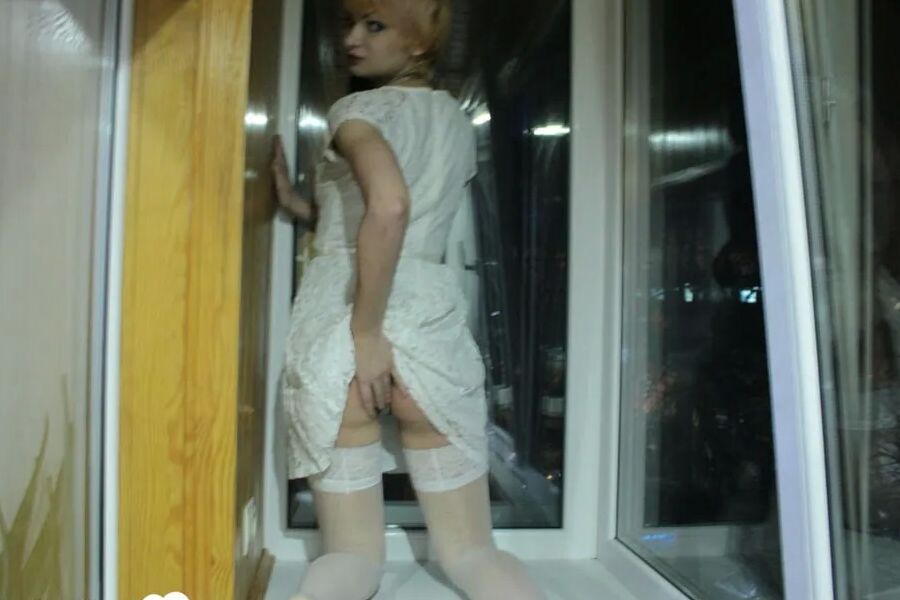 Hottie sits by the window in an outfit