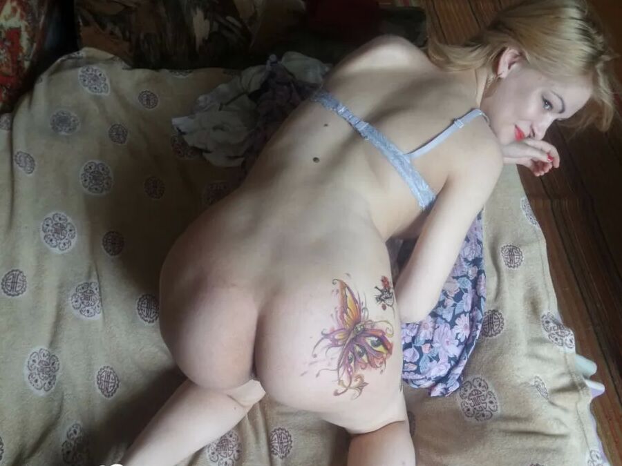 Luscious beauty with an ass tattoo fooling around