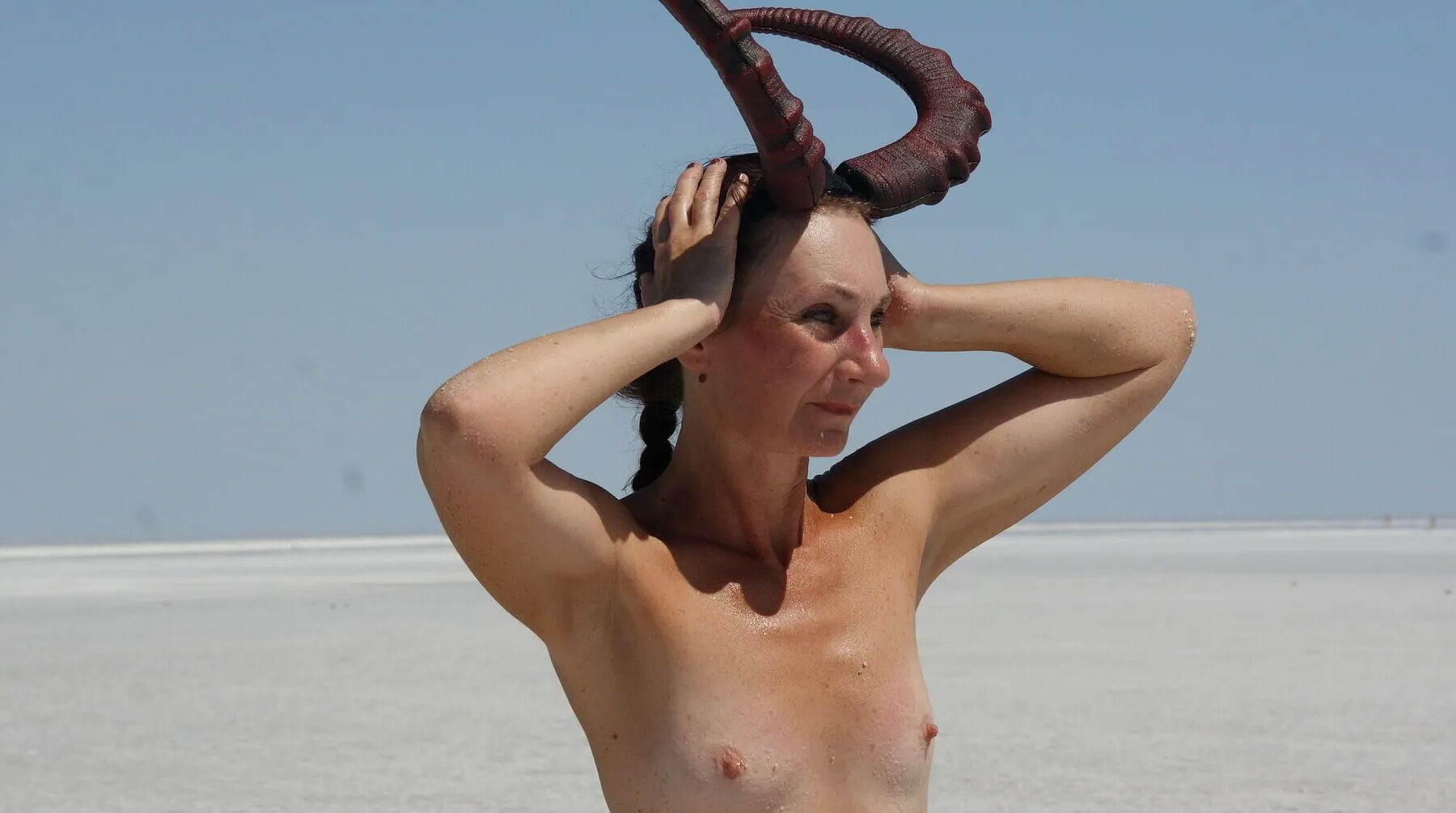 Standing naked on the salt of the salt lake Elton