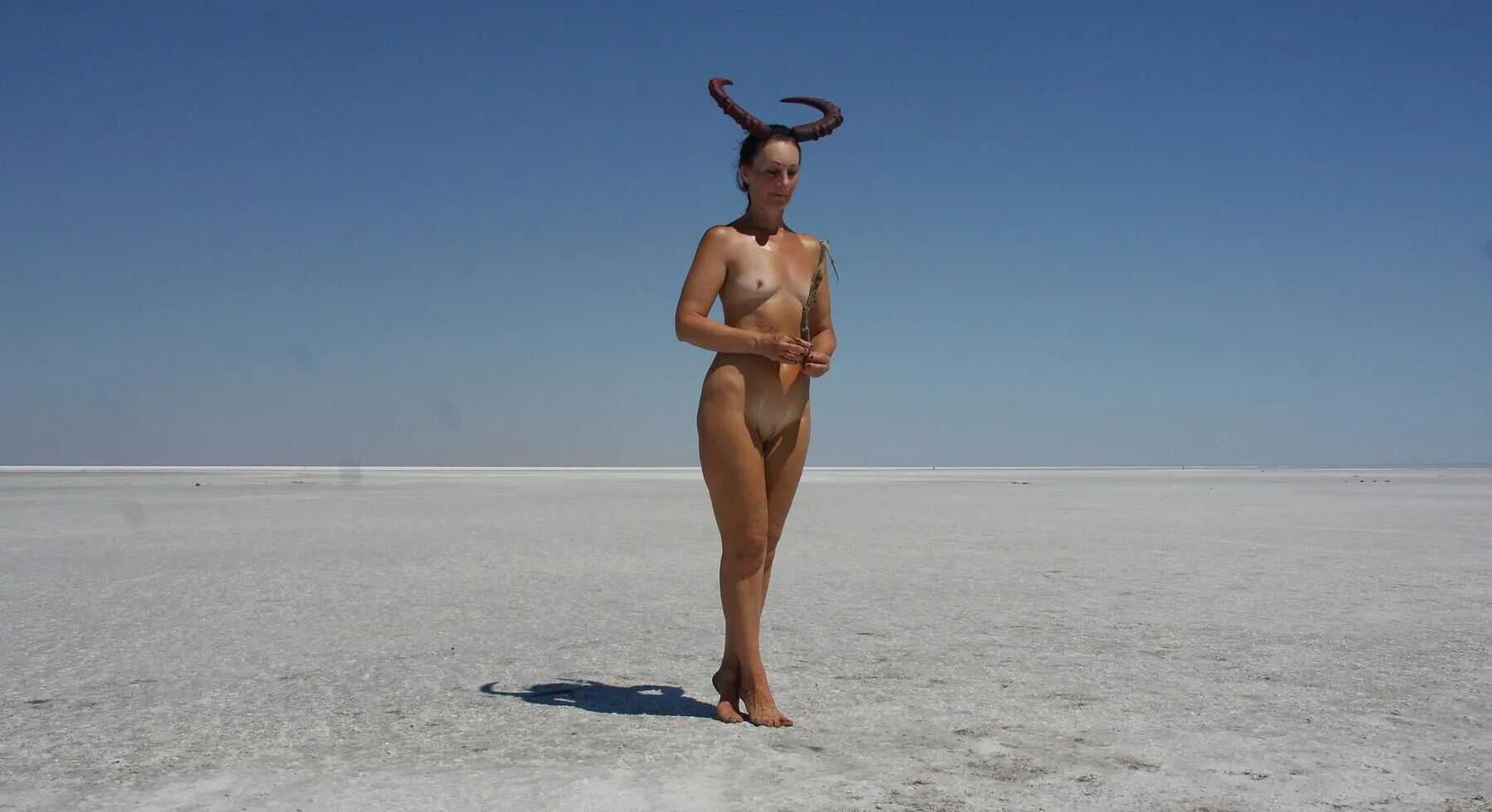 Standing naked on the salt of the salt lake Elton